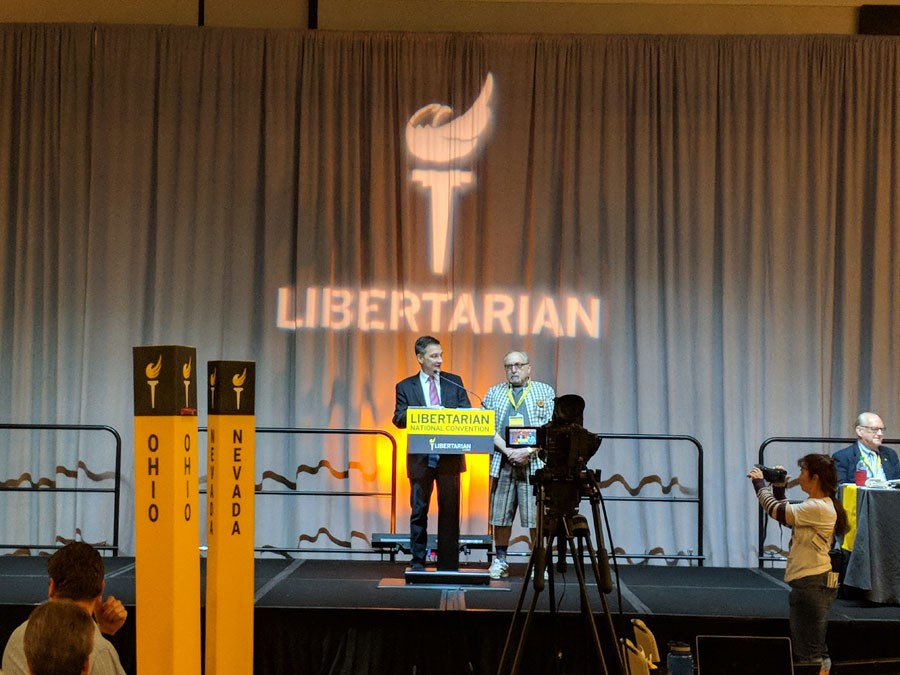 Libertarian Party of Libertarian National Committee Chair Nicholas Sarwark bestows an honorary life membership upon Libertarian Party of Michigan Founding member Dr. James Hudler, at the 2018 LNC Convention. Photo by Greg Stempfle.