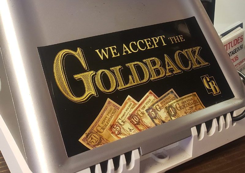 Goldback sticker on a point-of-sale machine in Utah 2022. Cropped photo by B. Shaffer.